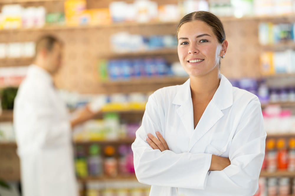 At pharmacy, girl apothecary waiting for customers, invite with gesture go to department of cosmetic