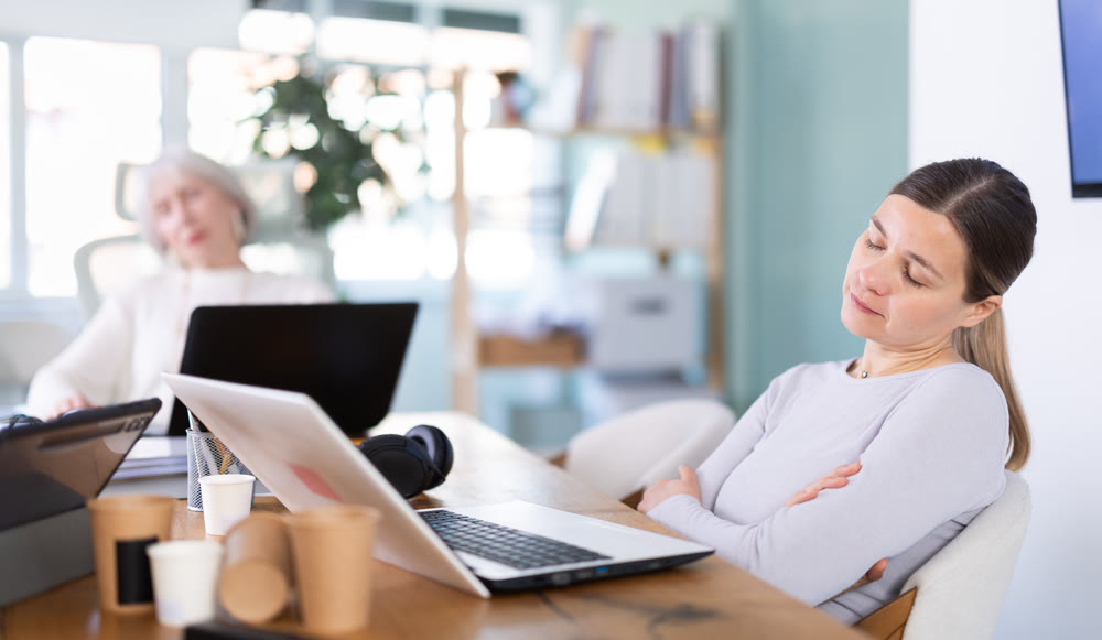 Tired elderly and adult female colleagues fall asleep while working