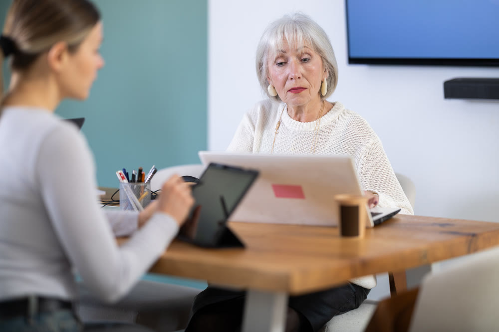 Elderly and adult women working in office