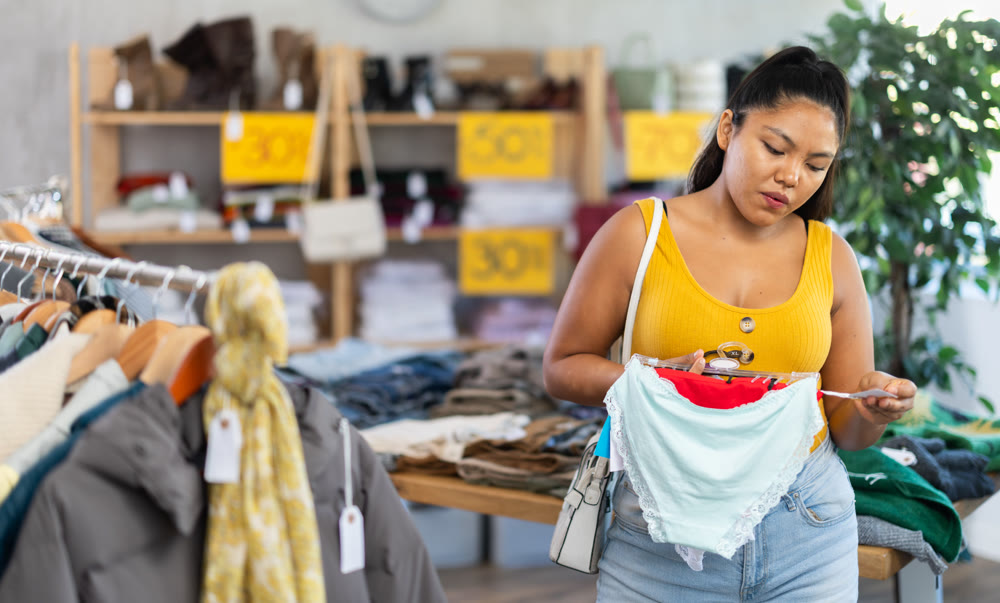 Young woman chooses panties in clothing store