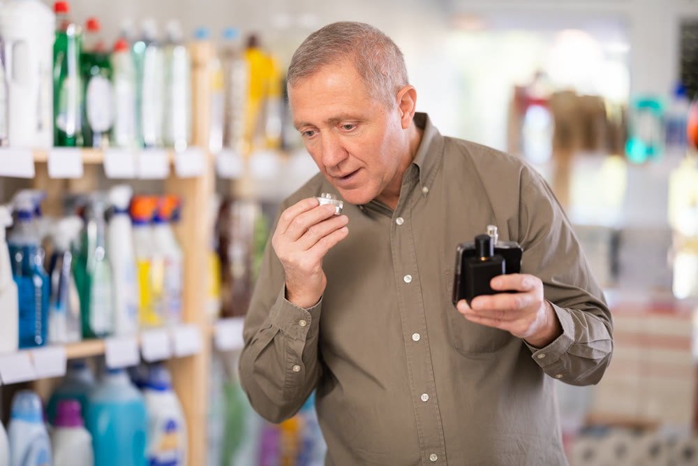 man chooses a perfume in a store