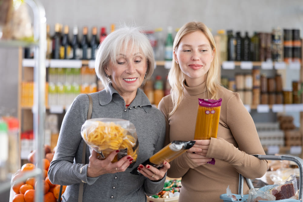 Family shopping at supermarket - choosing spaghetti and pasta in grocery section