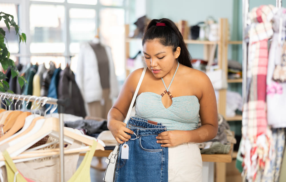 Latina chooses jeans in a clothing store