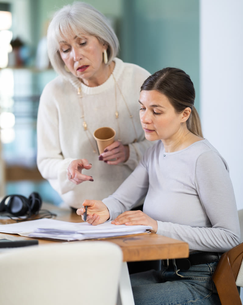 Mature manager advises a secretary on how to properly process documents