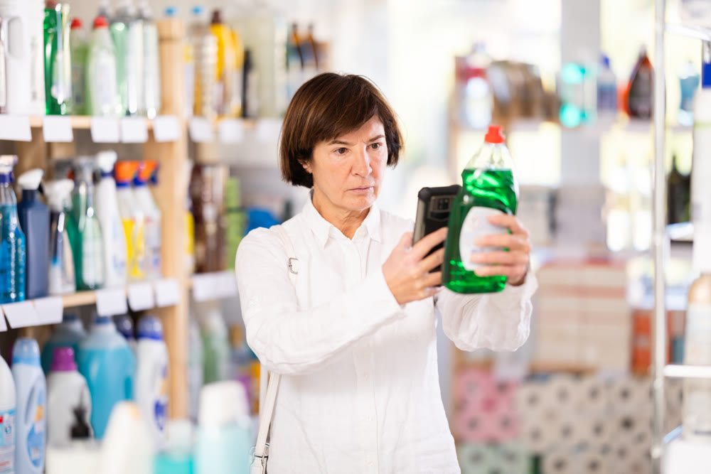 Elderly woman scanning qr code for dishwashing