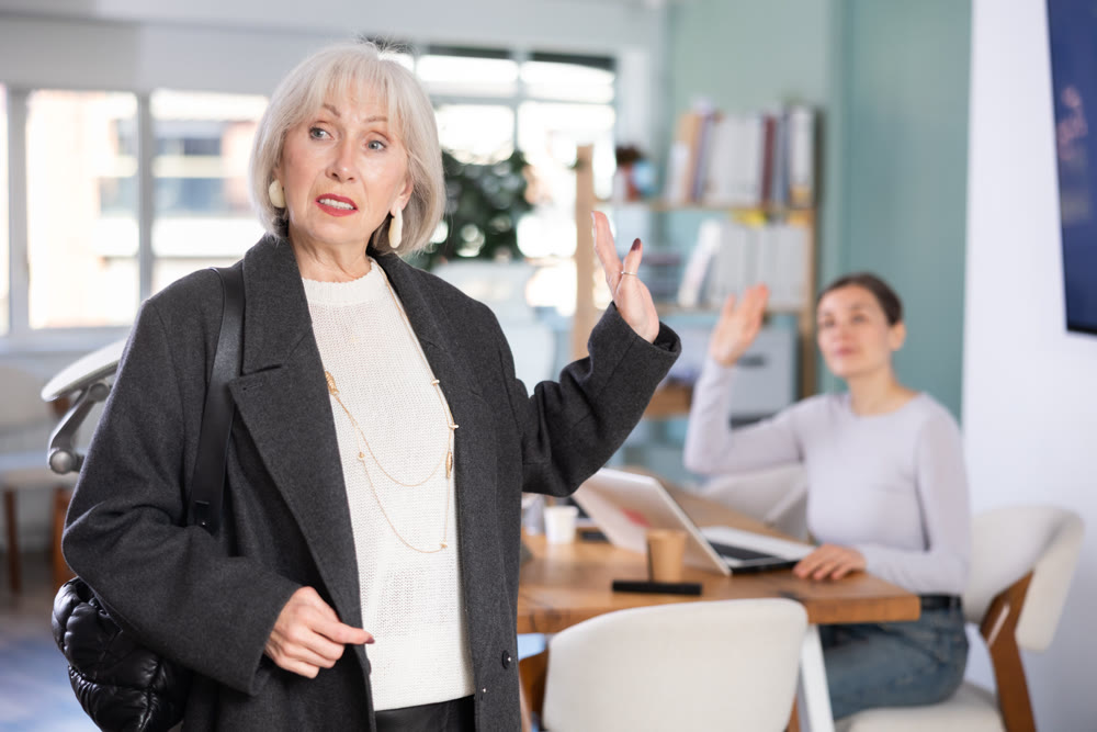 Senior woman says goodbye to colleague at end of working day