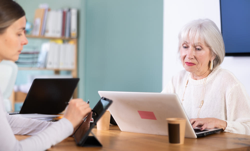 Elderly and adult women working in office