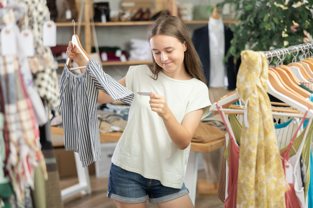 teenager chooses tops for the summer