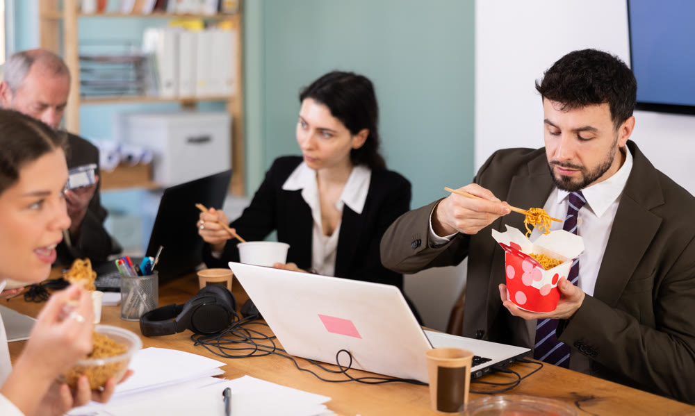 Male companys employees eat instant noodles, lunch time during break for staff