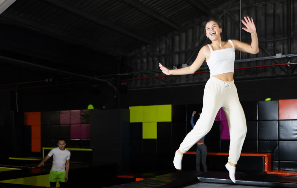 Woman sportswoman fitness jumping on club trampoline