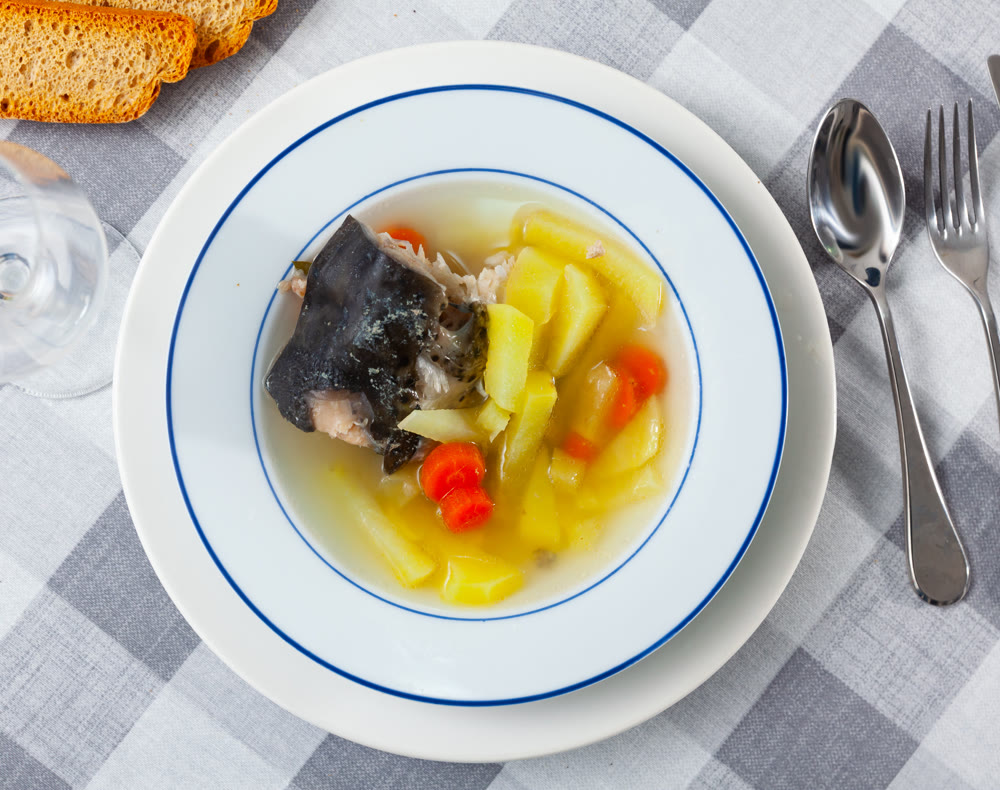 Salmon offal soup with vegetables - potatoes, carrots and parsley