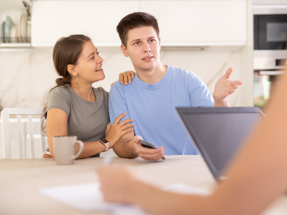 An insurance agent tells young couple the terms of property and life insurance