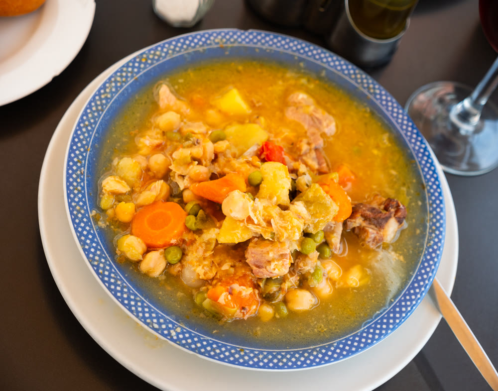 Plate with portion of hot chickpea and meat soup