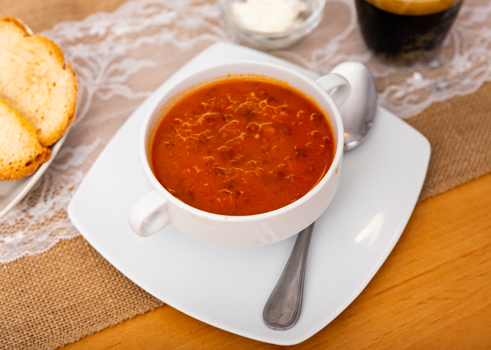 Borscht soup with beets served in bowl