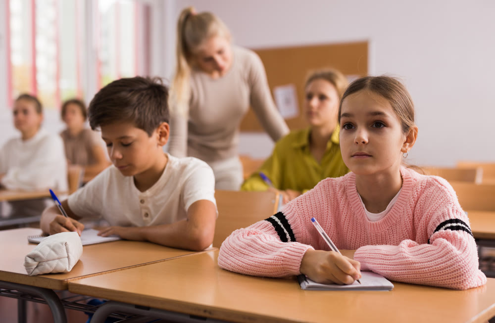 Boy and girl studying in classroom