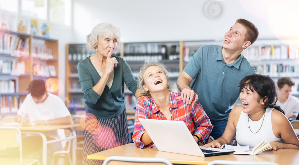 Mature female teacher asks the amused schoolchildren to behave a little quieter