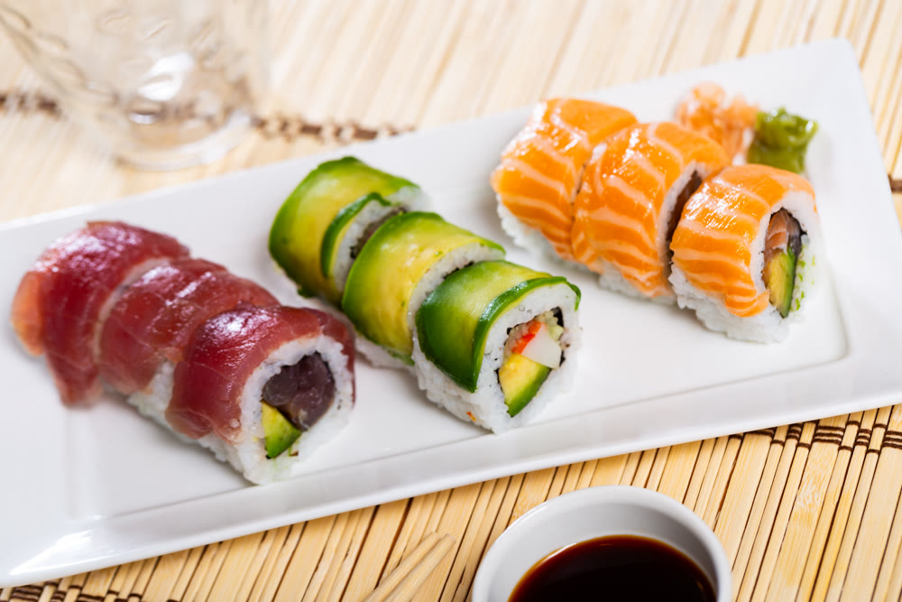 Uramaki set consisting of rolls with salmon, tuna and avocado