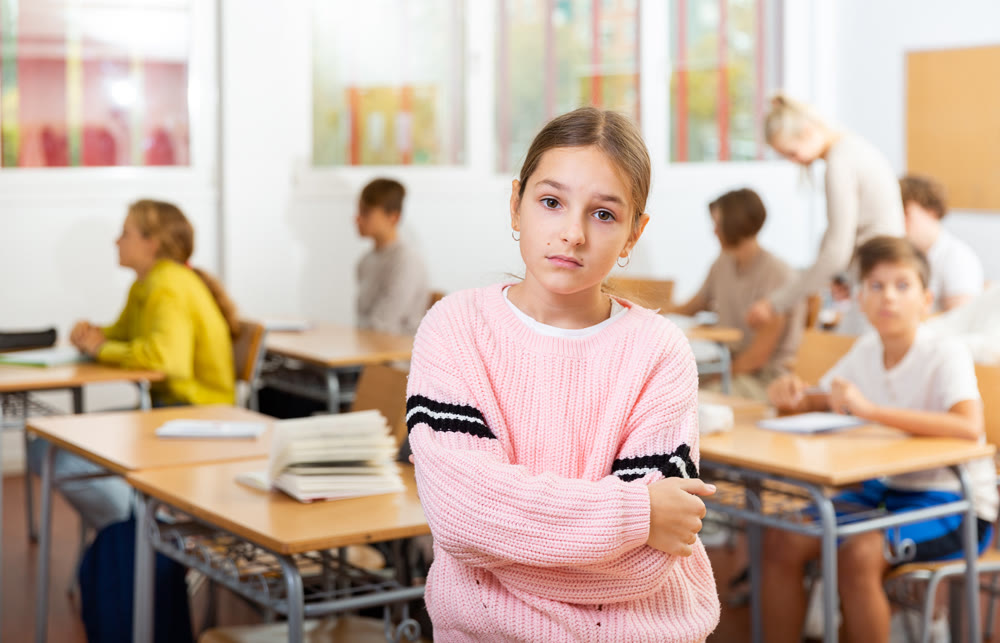 Girl feeling upset after getting bad mark at school