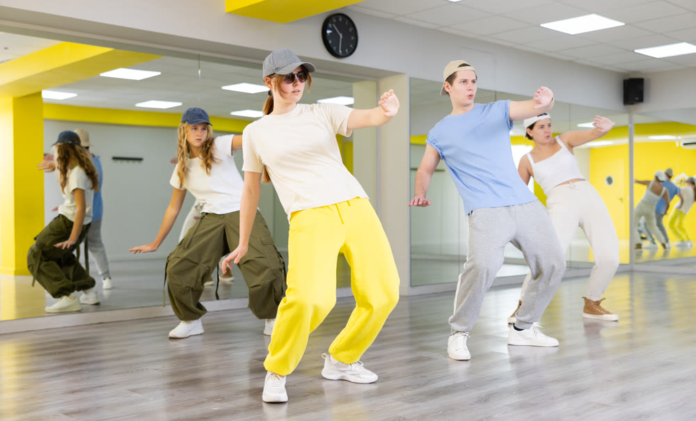 Sporty teenagers learning to dance in choreography class