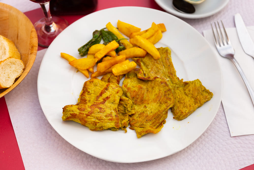 Pork secret served with potatoes and peppers