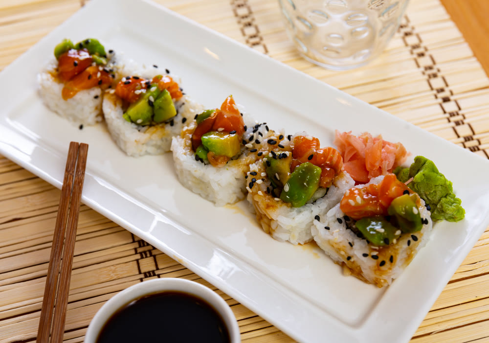 Sushi rolls with crab, cucumber, salmon, avocado seasoned with unagi sauce