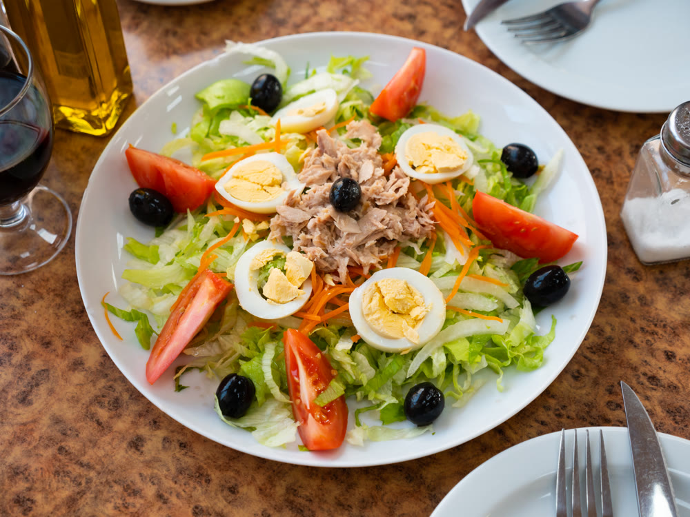 Delicious salad with canned tuna, boiled eggs and tomatoes