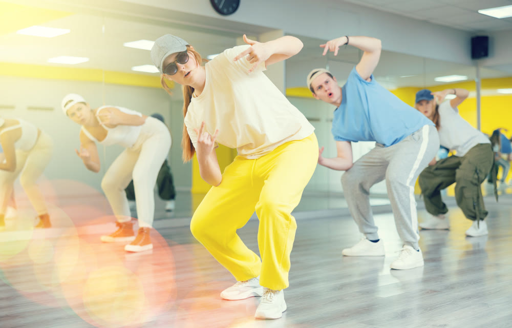 Expressive cool young dancers rehearsing their new dance during training together in studio