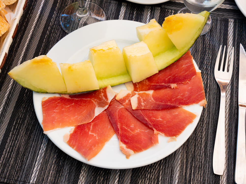 Tasty melon with thin slices of jamon, traditional french dish