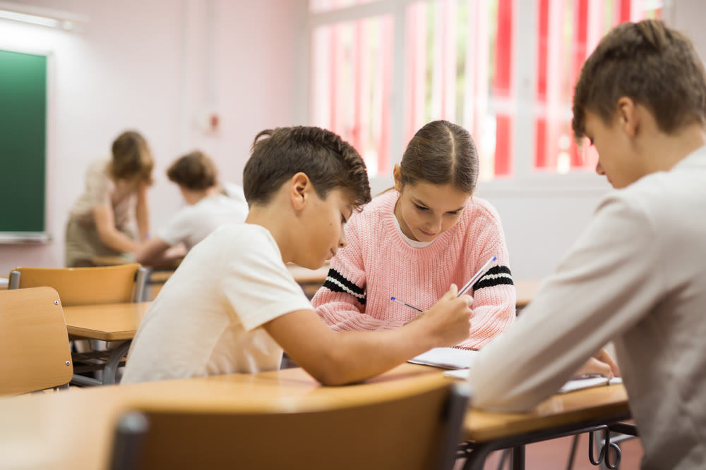 Pupils performing group tasks in classroom