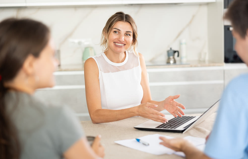 An insurance agent tells young couple the terms of property and life insurance