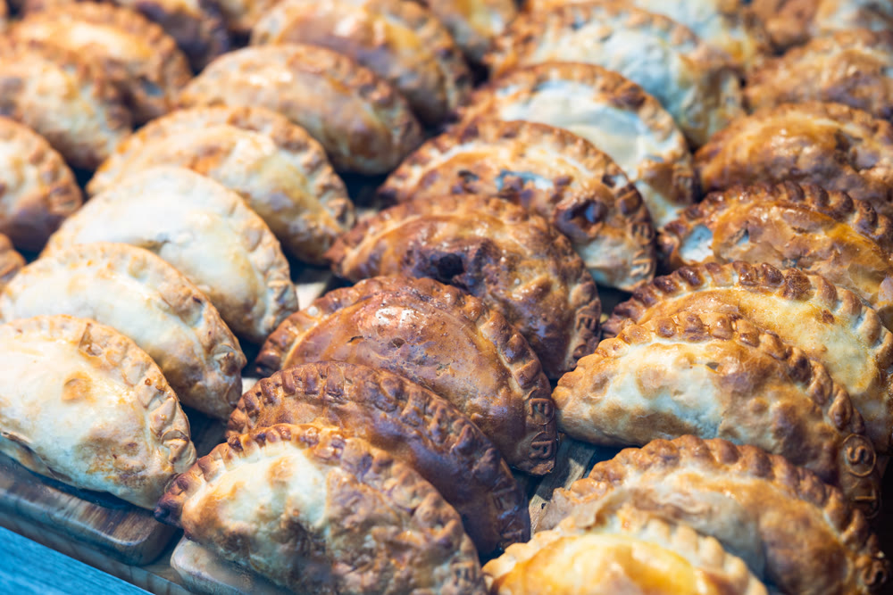 Delicious empanadas lined up in rows in store window