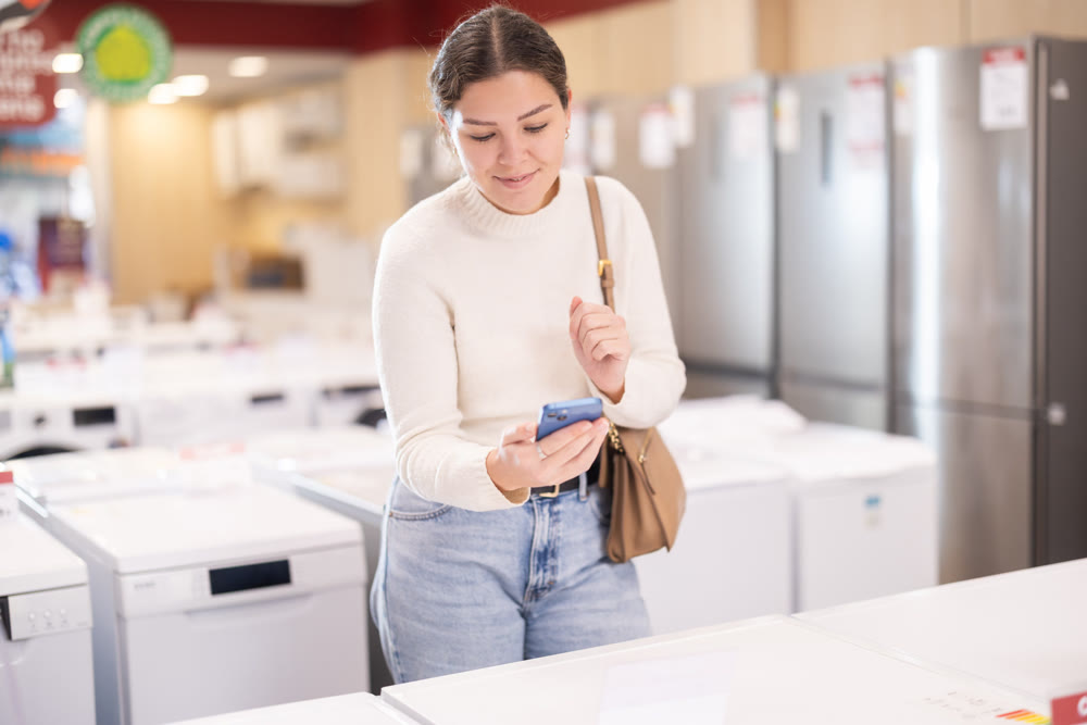 Young woman scans qr code for dishwasher