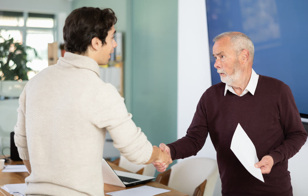 Confirmation of successful business negotiations with kind handshake, businessperson shaking hands and closing deal