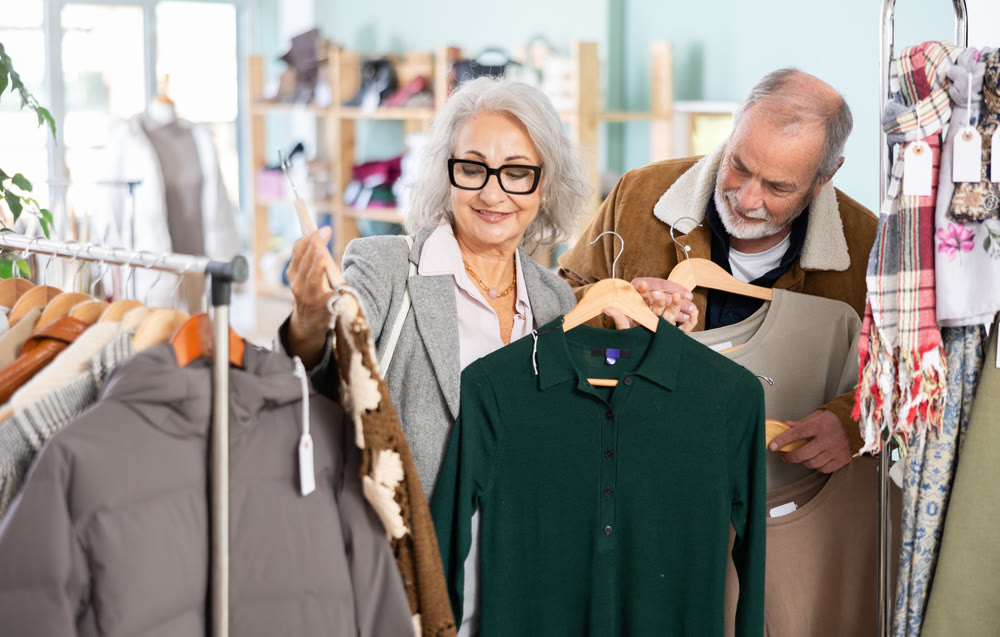 Mature couple spend time in shop and choose warm dress and T-shirt