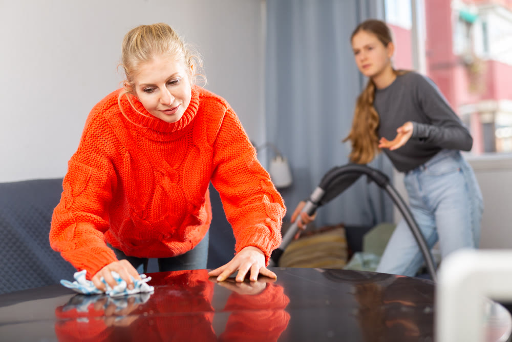 Woman wiping the table at home