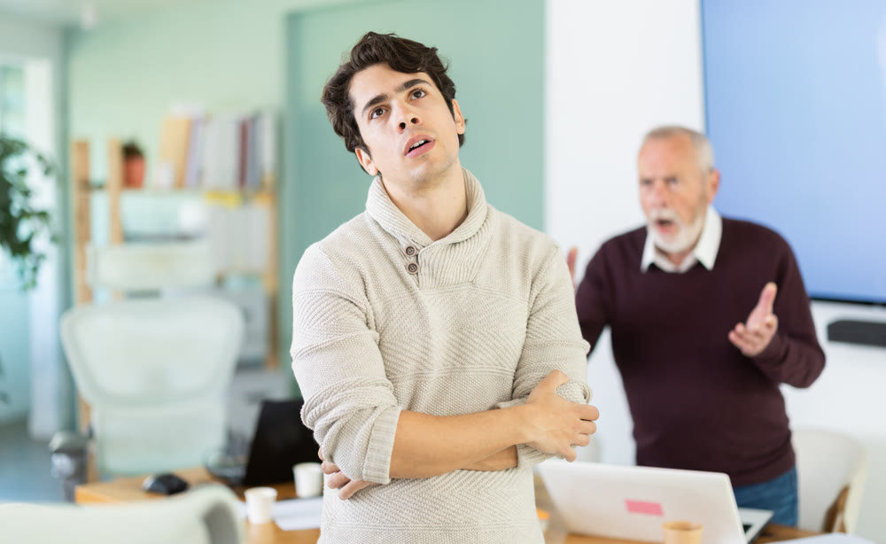 Elderly company director scolds young employee who made mistake at work