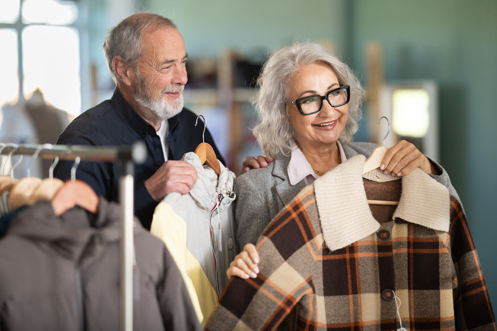 Family clothing store, senior couple customer chooses jacket or coat
