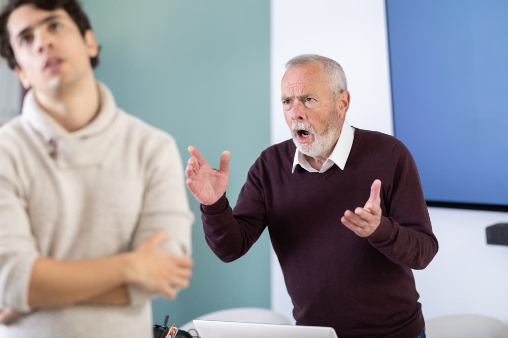 Adult man experiences abuse at work, is criticized by his mature male superiors.