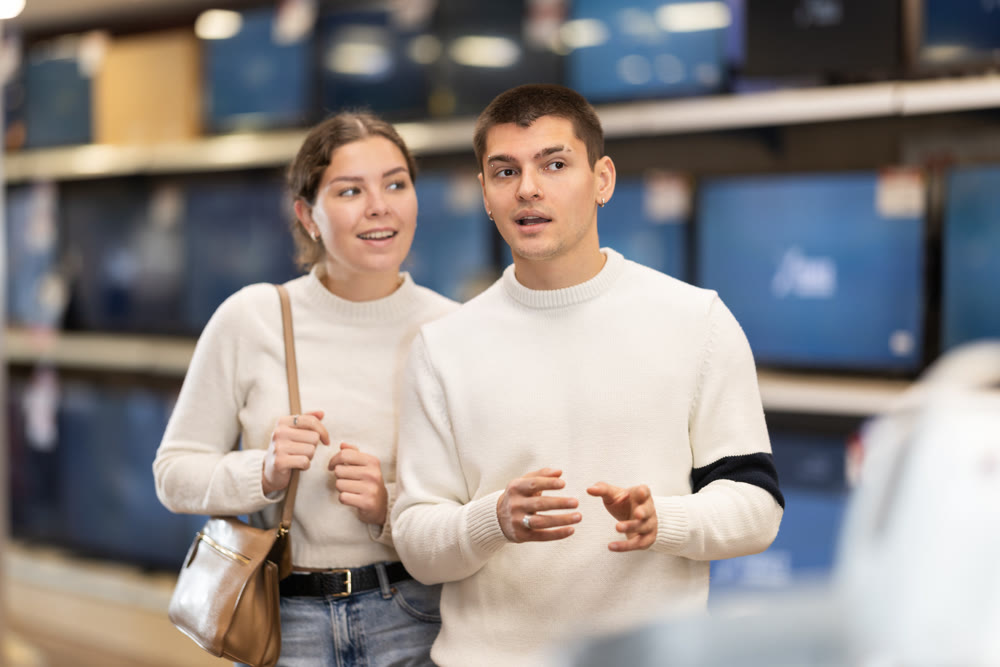 Couple client looking for something in household appliance store.