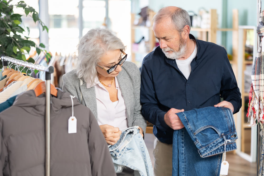 Mature man and woman choosing jeans in the store