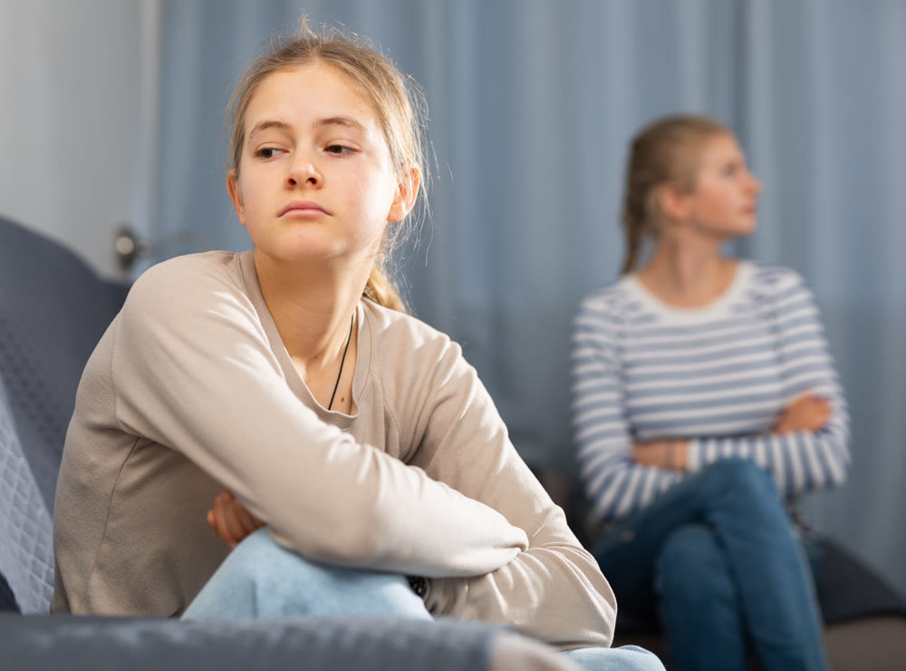 Mother soothes teen daughter after an quarrel