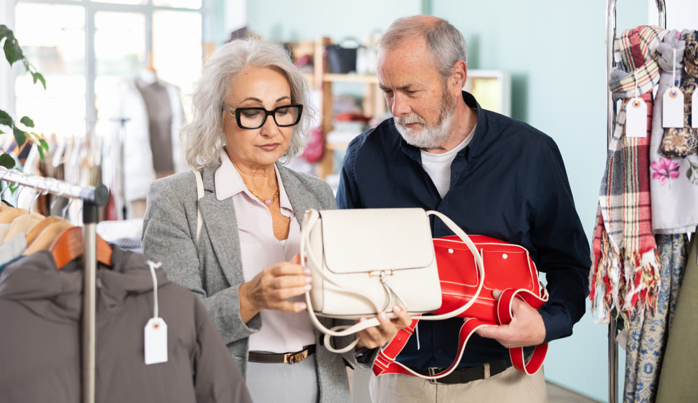Elderly couple chooses a stylish handbag