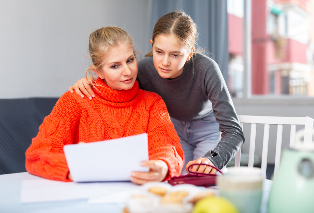 Mother and daughter reading letter