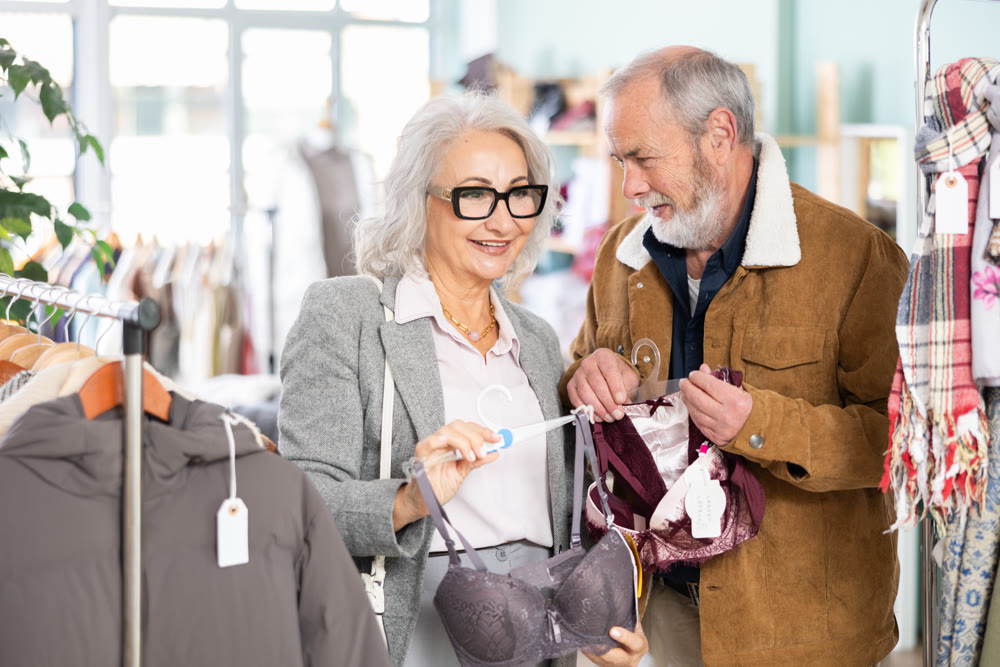 Mature couple spend time in shop and choose bra lingerie set