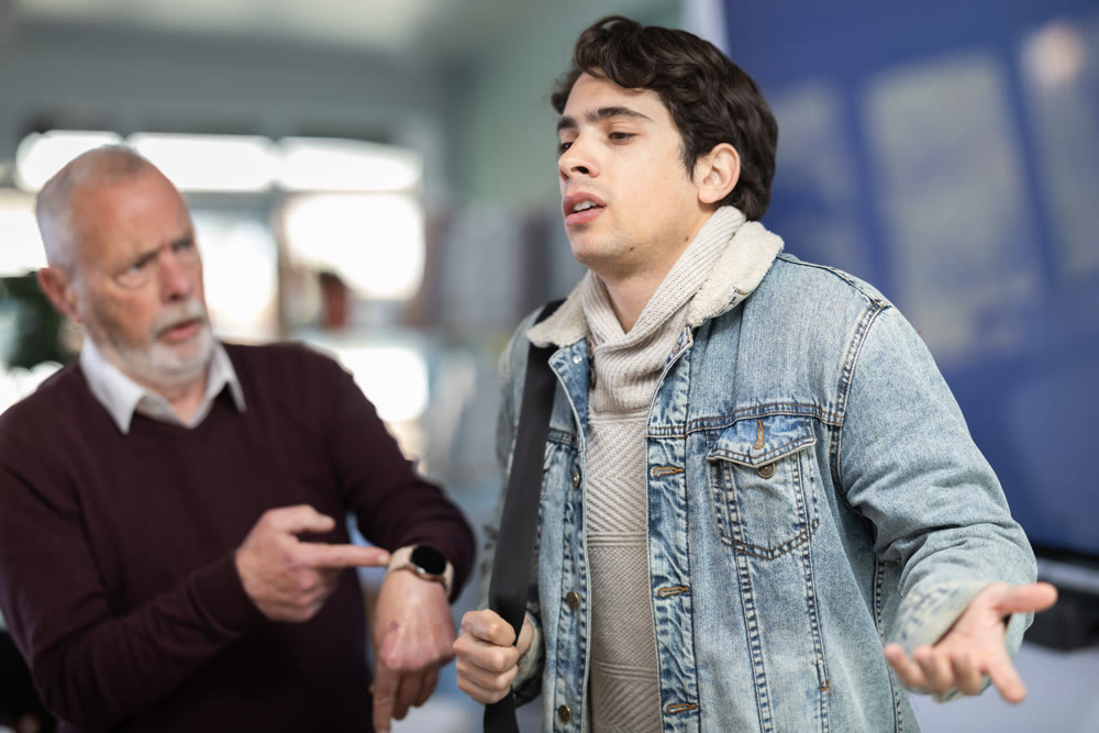 Upset guy employee of company quits job, and mature manager shouts after him.