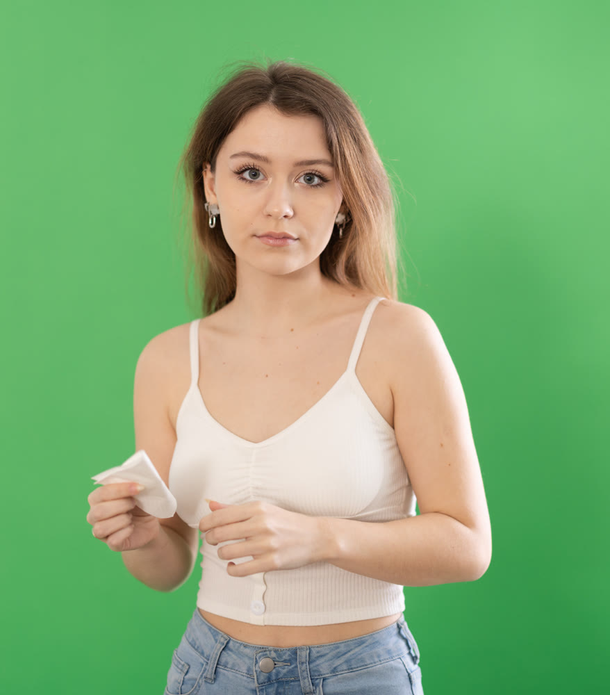Chroma key compositing. Portrait of sad crying girl on green background