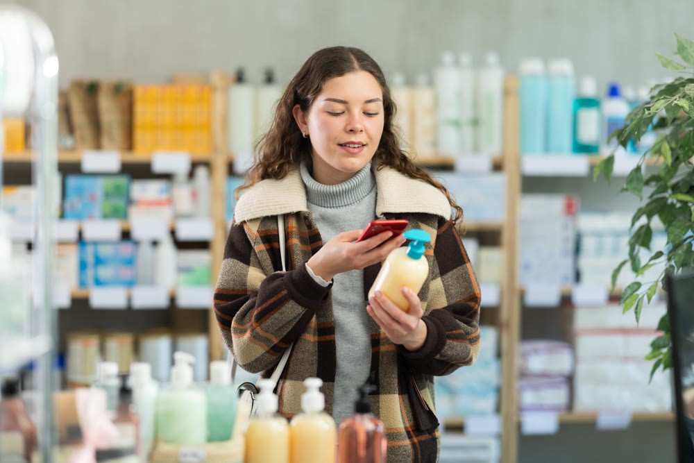 Young woman scanning qr code of hand soap