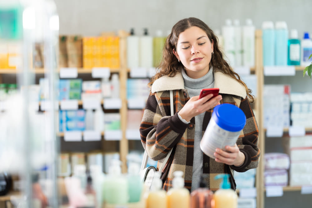 Young woman scanning qr code of baby formula