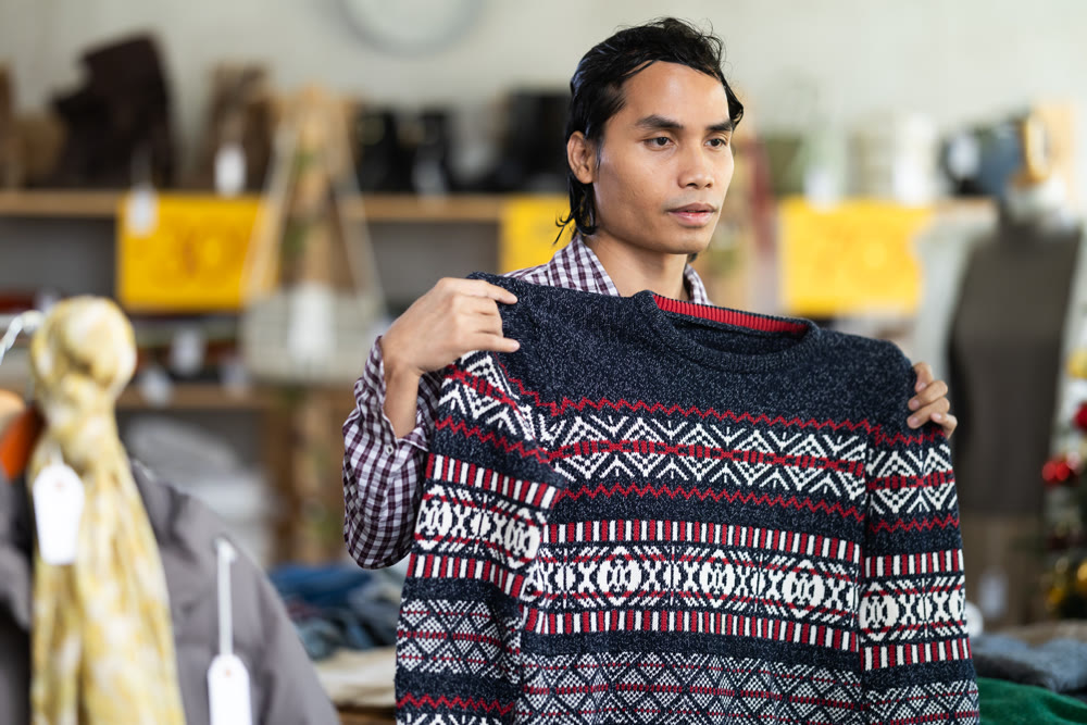 In chain shop, Indonesian man choose sweater