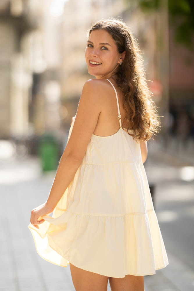 Young woman walks along city street